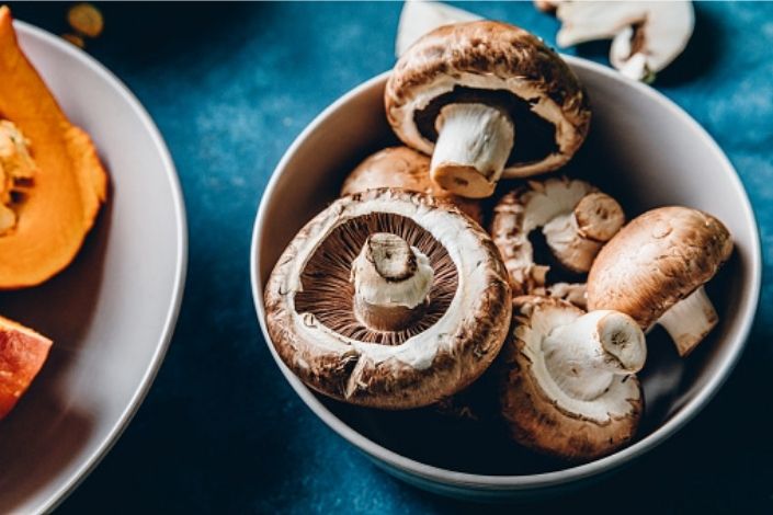 Bowl of white and brown mushrooms 