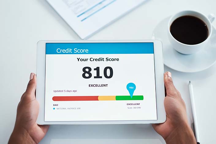 Shot of hands holding a digital tablet showing a credit score