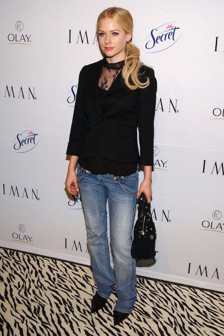 Avril Lavigne poses in a blazer and jeans for a book launch in 2005