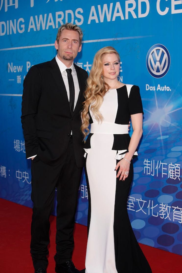 Avril Lavigne poses with then-husband Chad Kroeger at the Huading Awards Ceremony in 2013