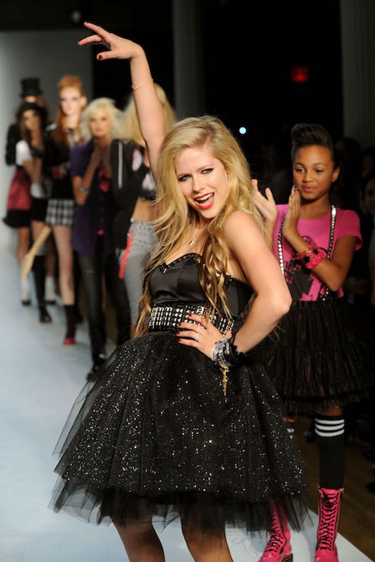 Avril Lavigne poses on the runway in one of her own designs for fashion brand Abbey Dawn in 2009
