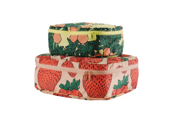 Two packing cubes in a strawberry print and a tangerine print