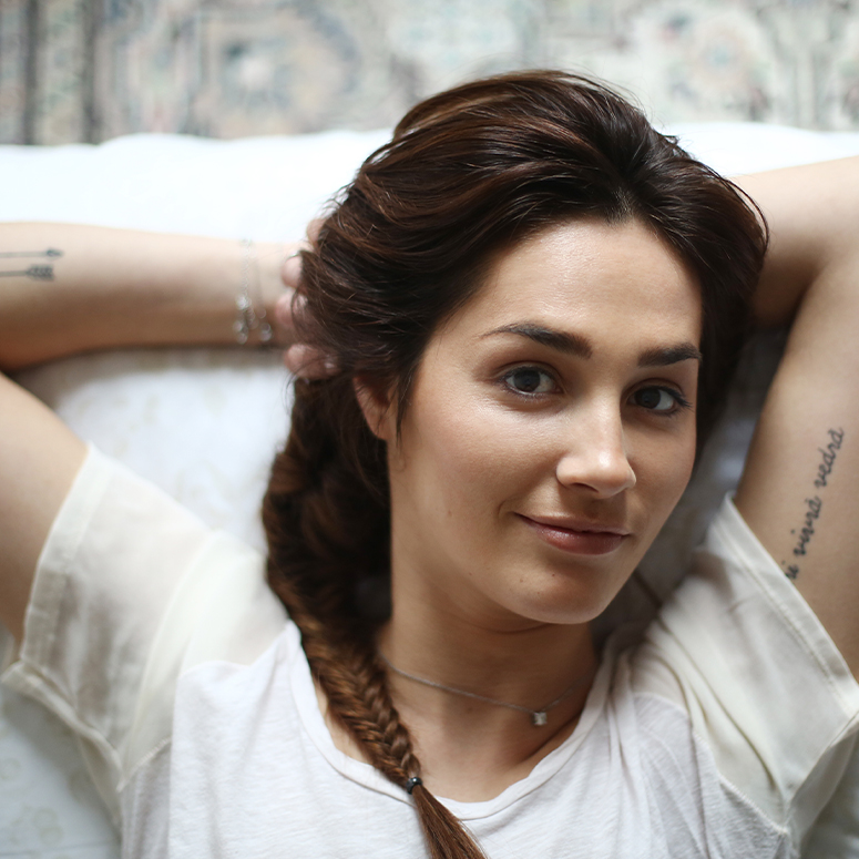 A woman with small arm tattoos