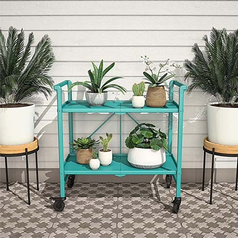 Teal bar cart on wheels with an assortment of potted plants