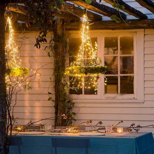 delicate string lights adorn an outdoor light fixture