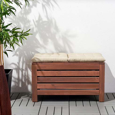 a wooden bench with white cushions