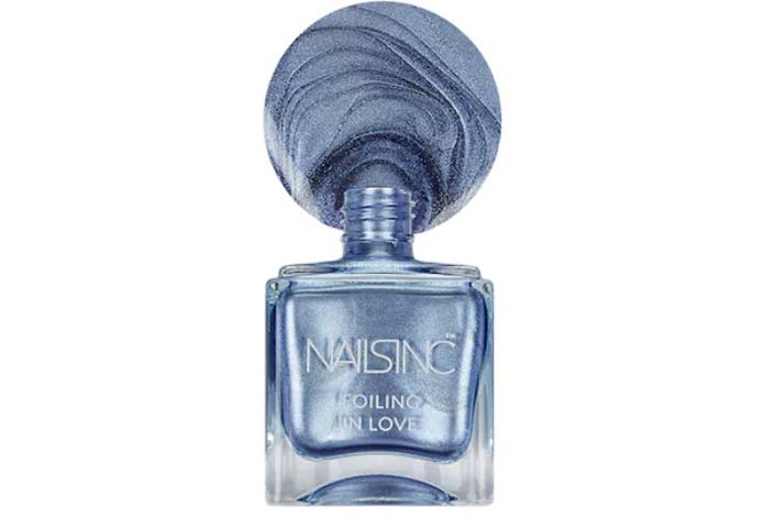 A bottle of sparkly denim-blue nail polish