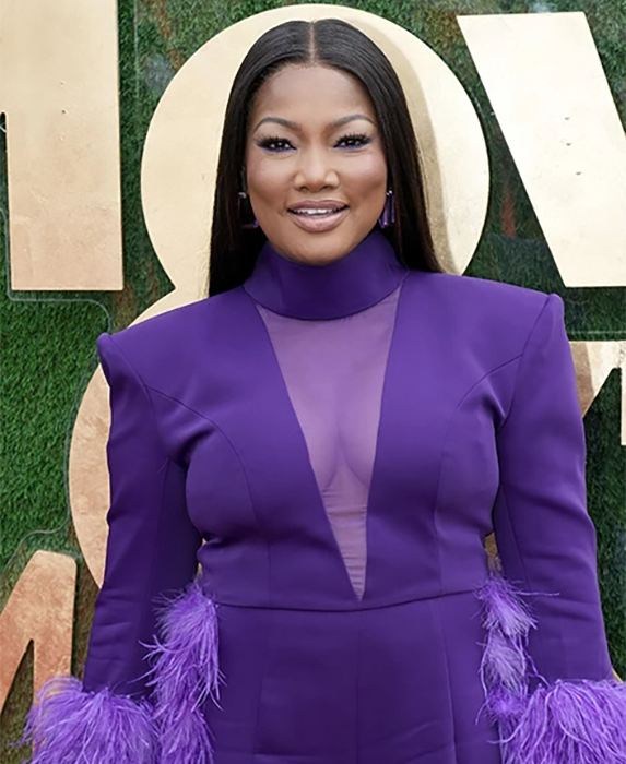 Garcelle Beauvais in a purple one piece with fringe