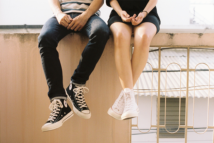 Two people sitting on ledge