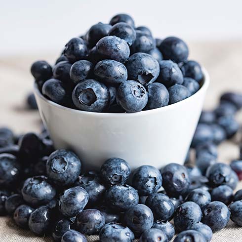 White bowl filled with blueberries