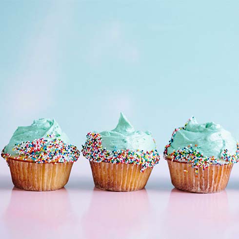 Three small cupcakes with blue icing