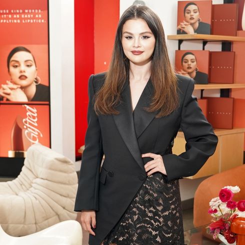 Selena Gomez poses in a Black blazer and laze skirt to promote Rare Beauty.