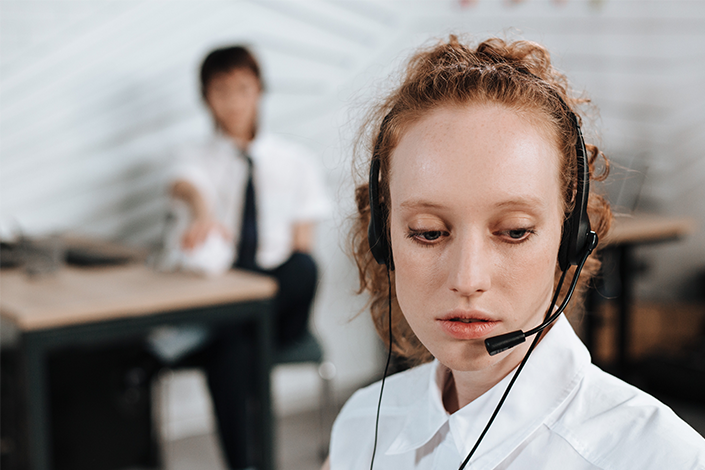 A young woman at work wearing a telephone headset