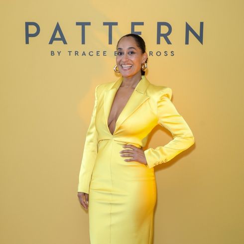 Tracee Ellis Ross poses in a yellow satin dress for the launch of her brand PATTERN