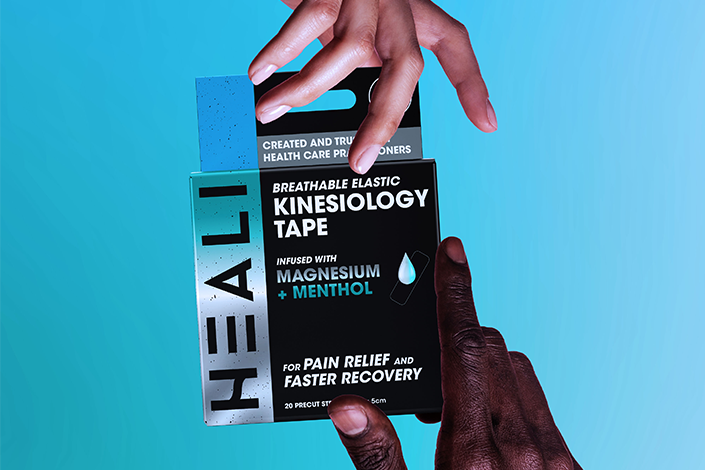 Two hands holding a Heali box