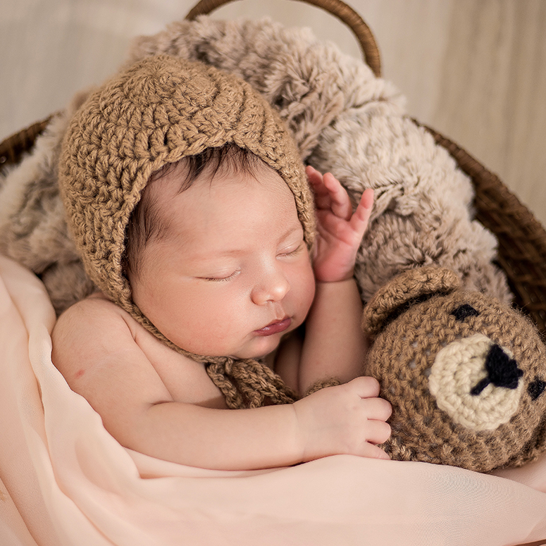 Baby sleeping in a brown hat
