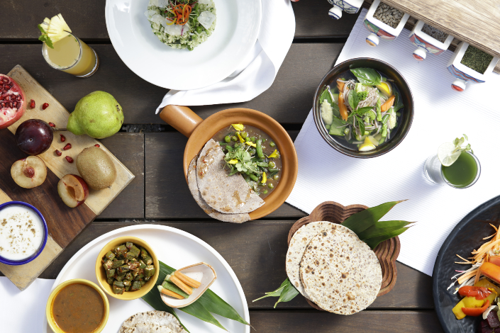 An assortment of plant-based Ayurvedic cuisine in bowls and on plates