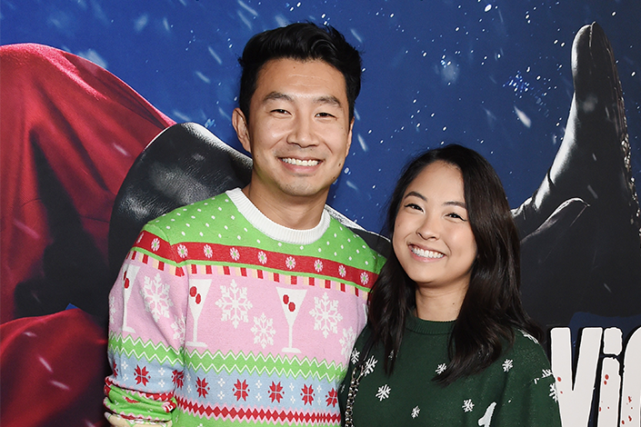 Simu Liu (L) and his girlfriend, both wearing holiday sweaters, at the premiere of "Violent Night" held at TCL Chinese Theatre on November 29, 2022 in Los Angeles, California. (Photo by Gilbert Flores/Variety via Getty Images)
