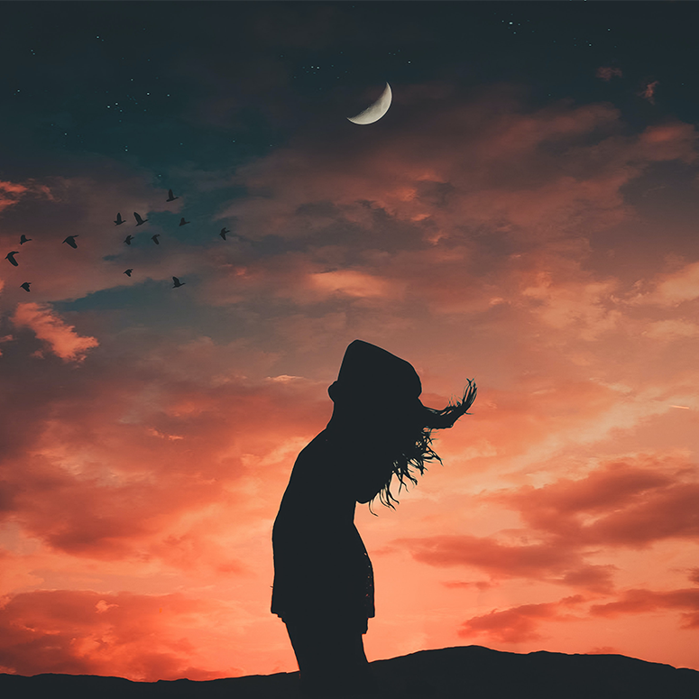 A shadowy person leaning back the moon and an orange sky in the background