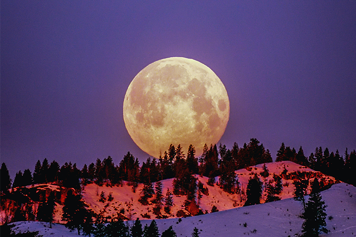 The moon over snowy mountains