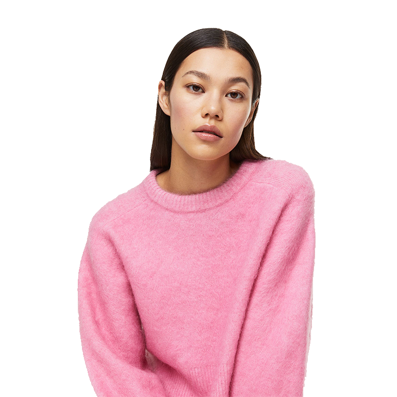 A woman wearing a pink mohair-blend sweater