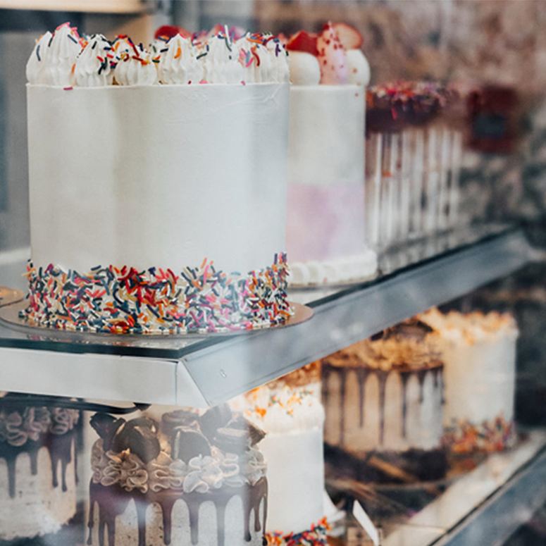 Cakes in a bakery display case