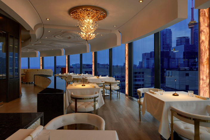 Restaurant tables at Don Alfonso 1890 with a panoramic view of the downtown Toronto skyline