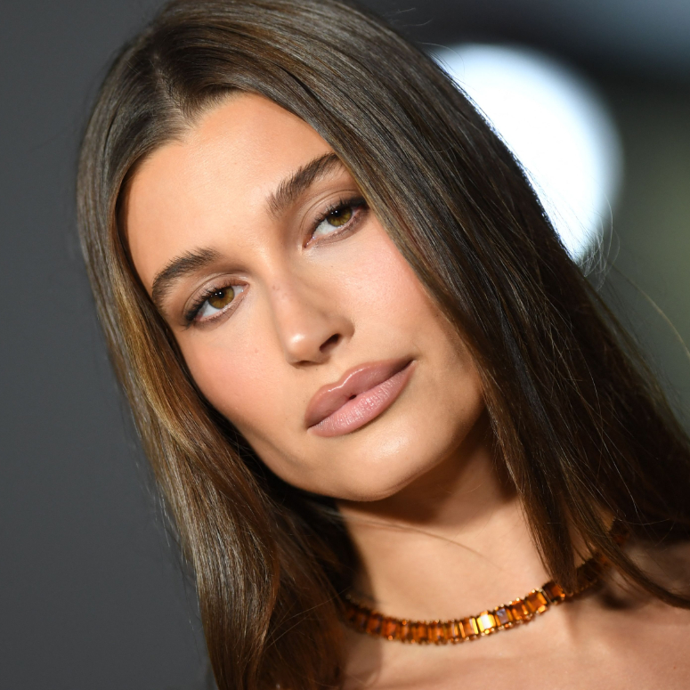 A closeup shot of Hailey Bieber at the 2nd Annual Academy Museum Gala, with her makeup beautifully contoured