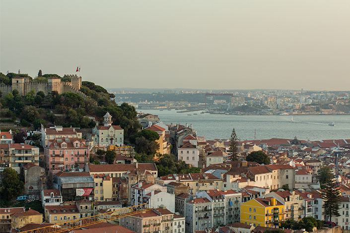 A view of colourful houses and the water in Lisbon