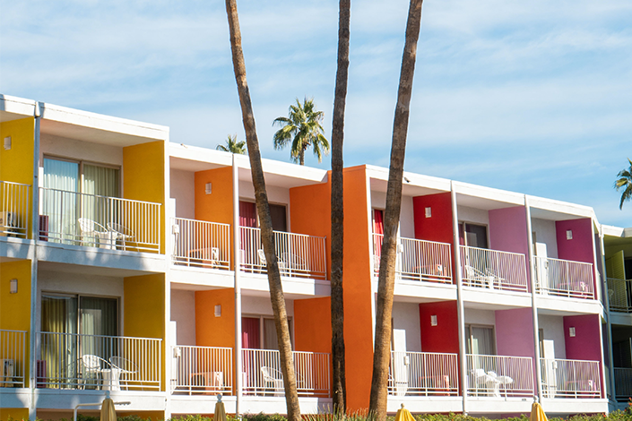A colourful hotel with palm trees in Palm Springs