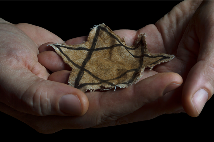 Jewish badge in the hands of a man.