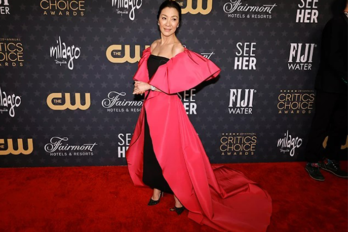 Michelle Yeoh in a floor-length red-and-black gown at the Critics Choice Awards 2023