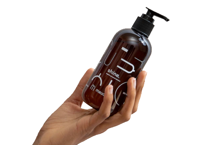 A hand holding a bottle of personal lubricant