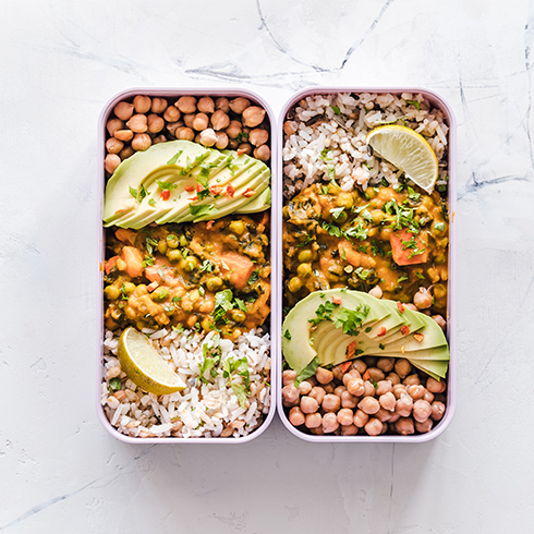 Two dishes of healthy food like beans and avocado