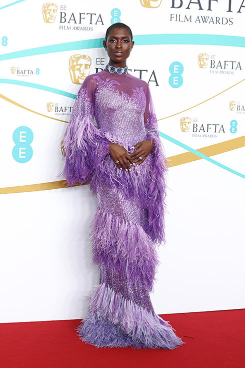 Jodie Turner-Smith in a purple feathered gown on the BAFTA Awards red carpet