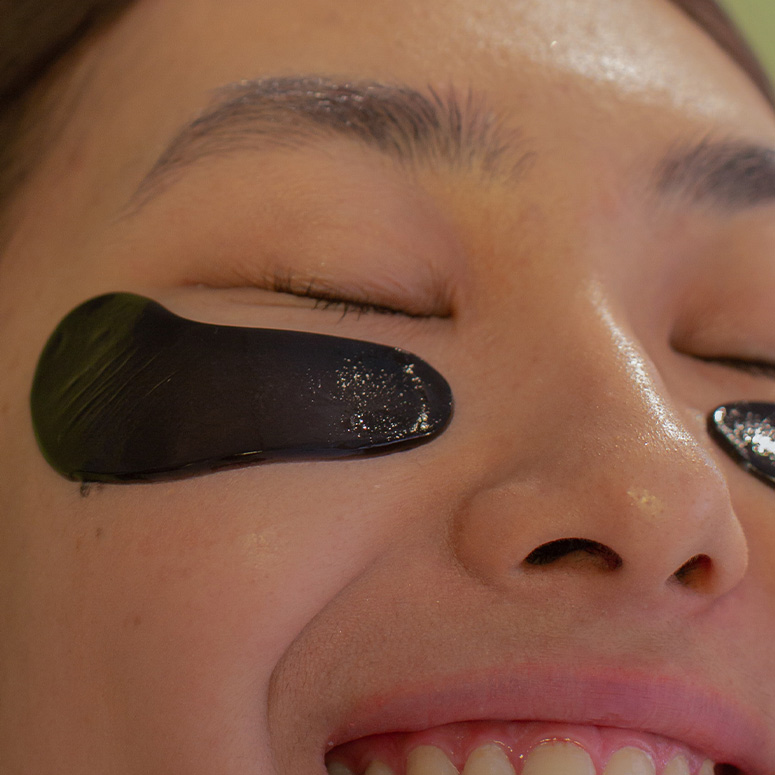 Close up of woman's face wearing under eye patches