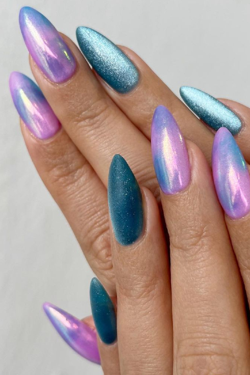 A mermaid-inspired set of nails with a metallic purple and blue marble and a blue cat eye nail