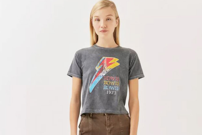 a young woman wearing a grey vintage graphic David Bowie tee
