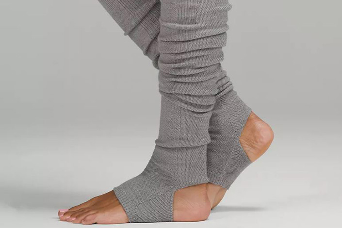 a woman's legs with grey legwarmers on