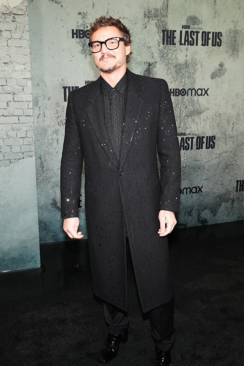 Pedro Pascal at a Hollywood event in a long black suit with sparkles