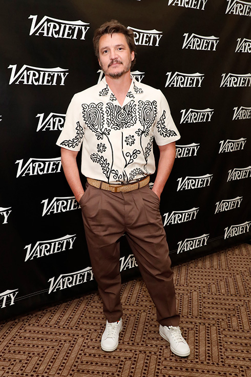 Pedro Pascal at a Hollywood event in a patterned white short-sleeved blouse