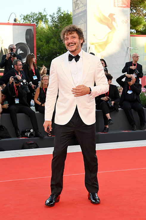 Pedro Pascal at a Hollywood event wearing a white suit jacket