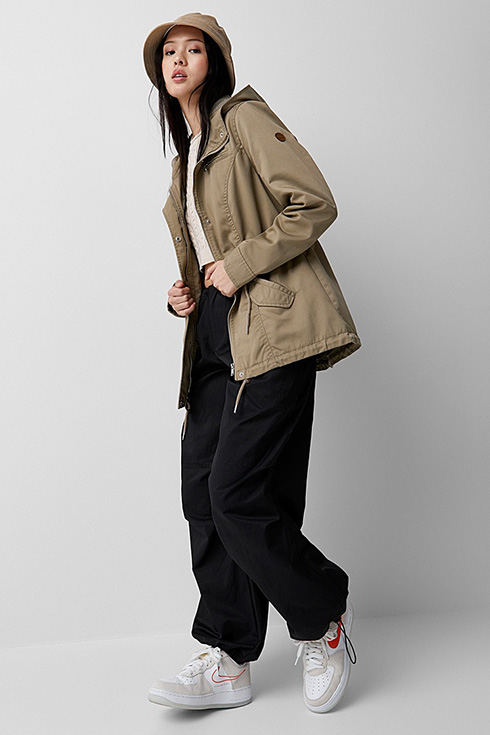a young woman wearing an oversized utilitarian jacket