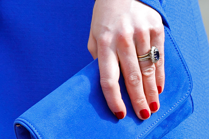 A closeup of Kate Middleton's red nail polish