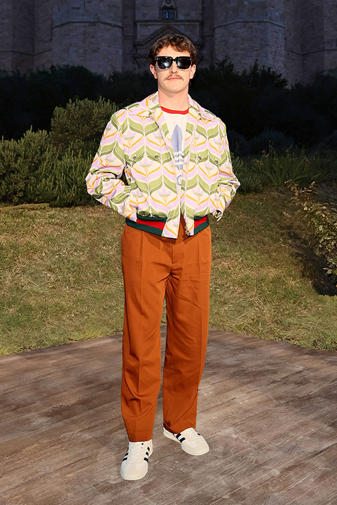 Paul Mescal in a colourful jacket and and orange pants