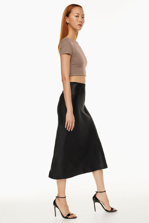 Woman wearing a black satin maxi skirt