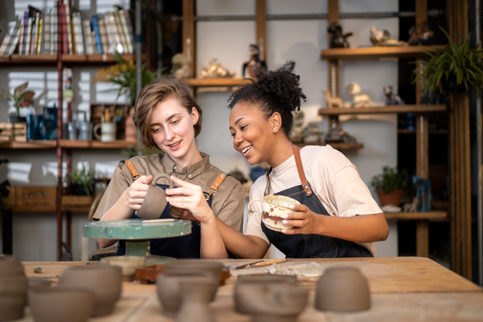 Two women enjoying a pottery class